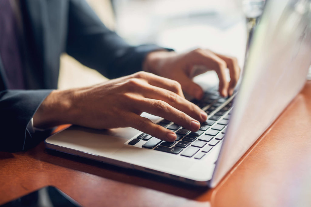 Woman on laptop searching for internet providers without data caps