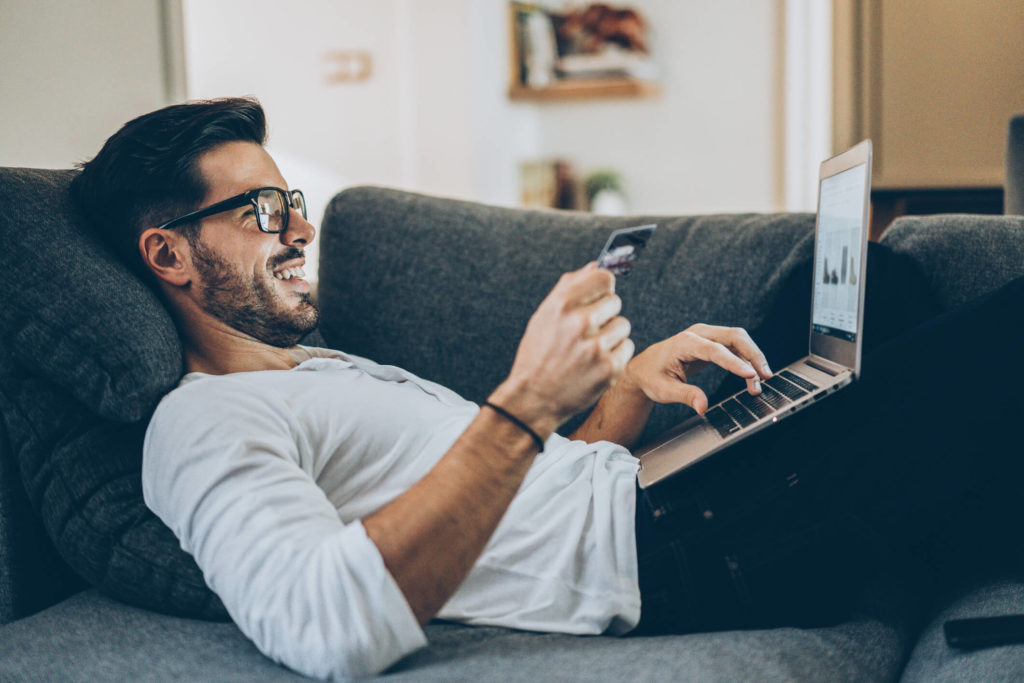 Man paying bills on laptop