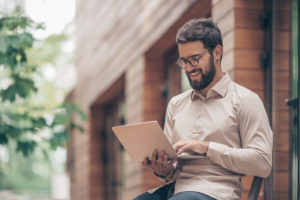 Man using laptop outside