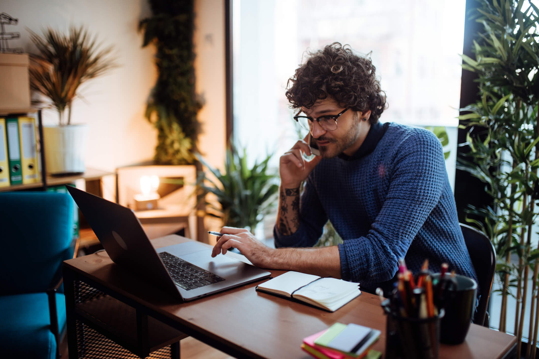 Man working on laptop using Surfshark VPN