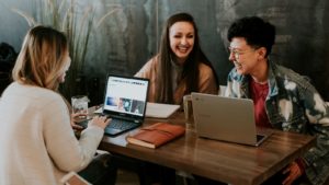 Photograph of three youths absolutely ecstatic to have super-fast internet