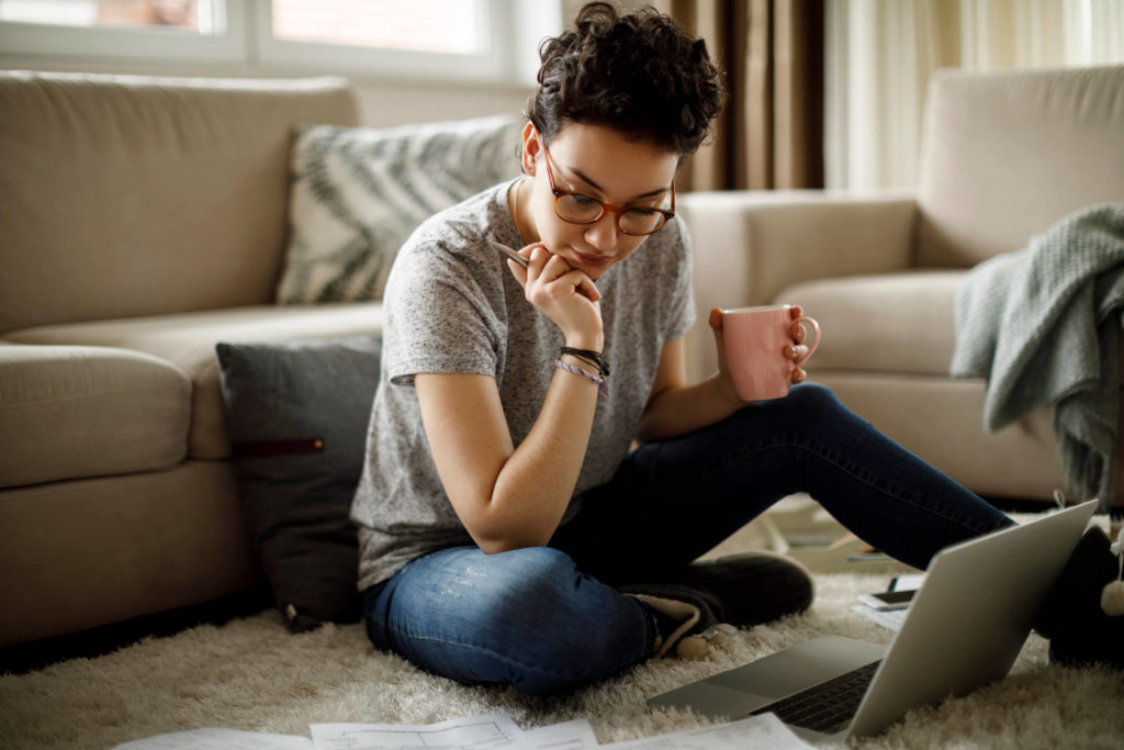 Woman on laptop comparing IPVanish vs Surfshark