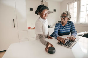 Young and old woman setting up Echo Dot