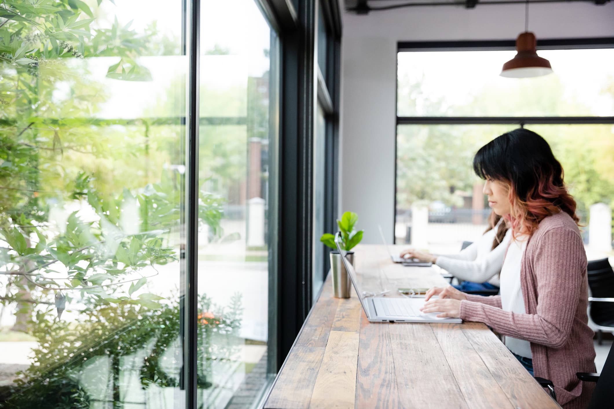 Woman using laptop public space - bets vpn for windows