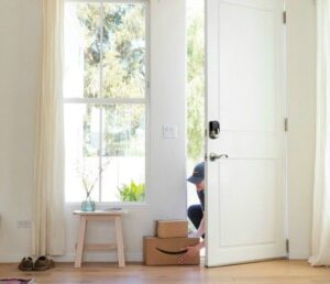 Delivery person setting packages inside a front door