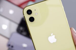 Hand holding yellow iPhone 11