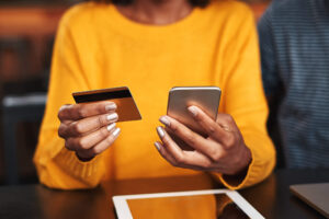 Woman looking at app with credit card