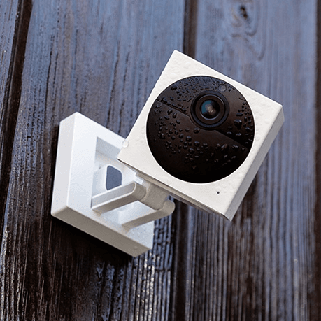 Wyze Cam v2 shown mounted on a dark wood wall