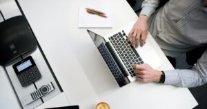 business man on a laptop at his white desk