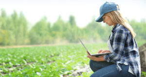 Stock Photograph of a woman using satellite Sky Muster NBN to access the internet on a farm