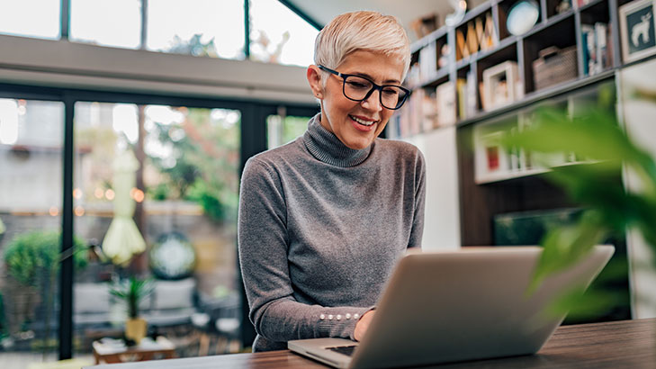 short haired woman using laptop