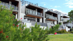 apartment buildings flanked by green plants