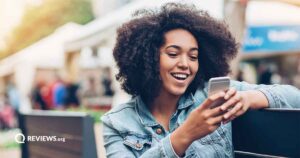 Woman looking at cellphone outside