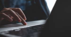 a close up of a hand on a laptop mouse