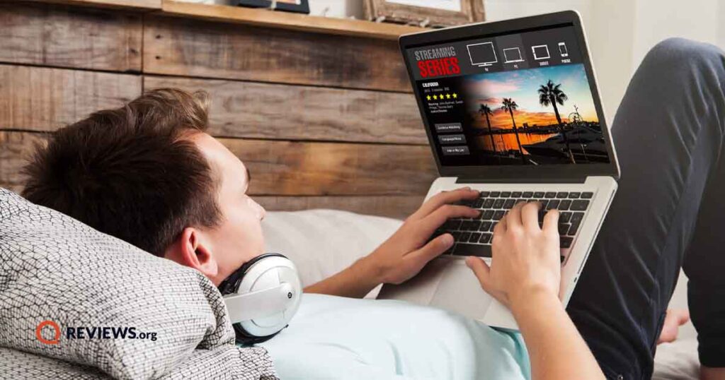 young man relaxing and working on laptop