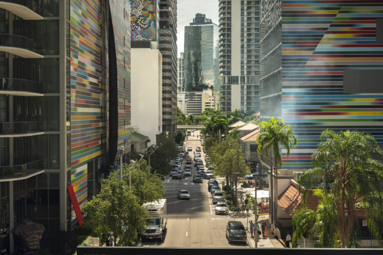 Miami, Florida - November 2, 2022: Modern downtown luxury shopping mall district and apartment buildings skyscrapers rise from the city streets in the financial business area of Miami Florida