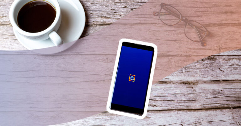 android phone on a table with aldi logo on the screen