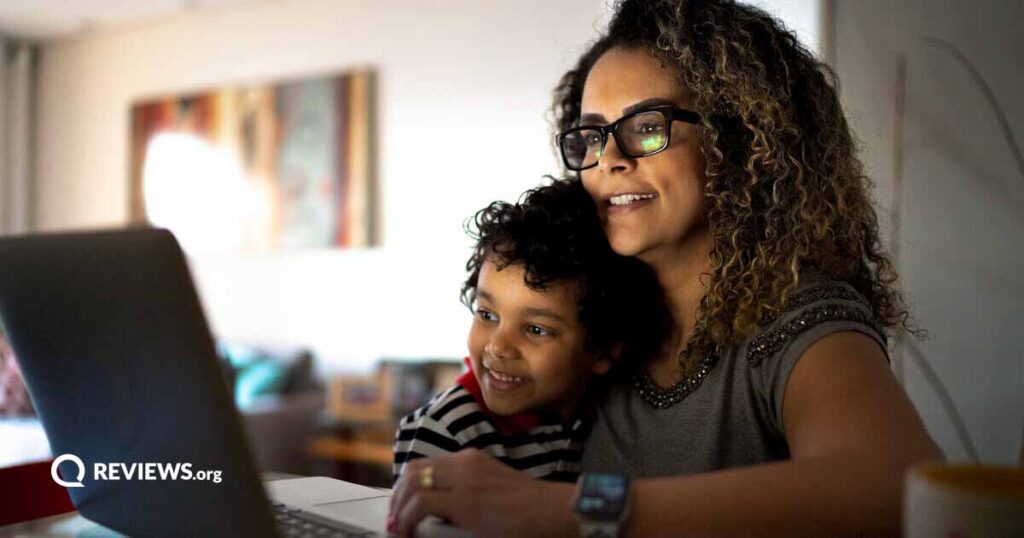 A woman and her child use a laptop together