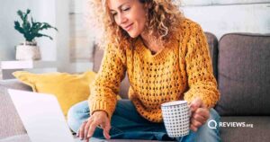 Woman searching for fast internet service providers on her laptop at home