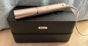 Shark FlexStyle hair styler on top of a large black carry case with the Shark logo on it