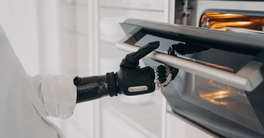 black robot arm opening an oven